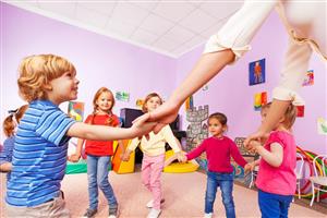 Group of pre-school children in a play circle with teacher